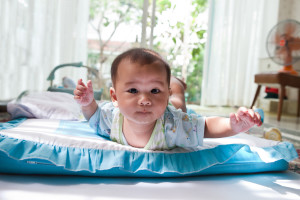 Baby on bed on tummy.